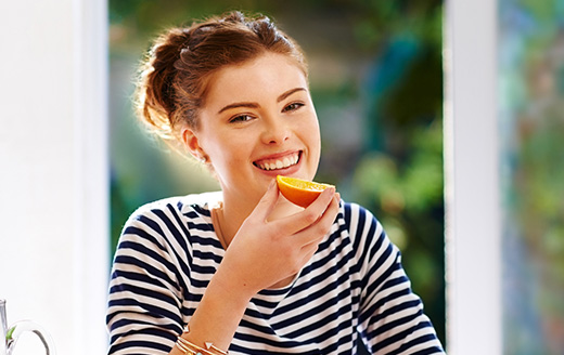 Benefits of dance- happy woman eating fruit